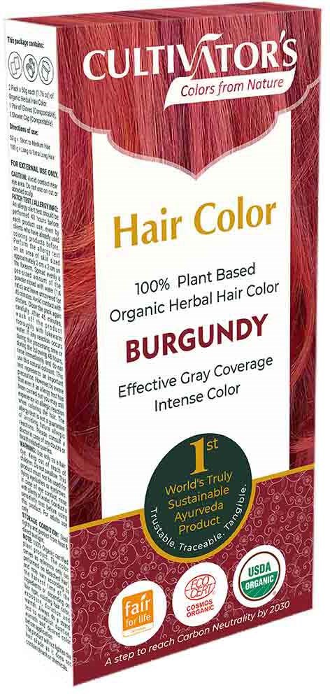 Roze en witte doos voor haarverf met merk, kleur en milieuvriendelijke en certificeringssymbolen.