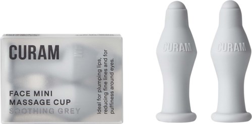 Eine Box mit der Aufschrift 'QUARAN Face Mini Massage Cup' und zwei weiße Massagebecher daneben.