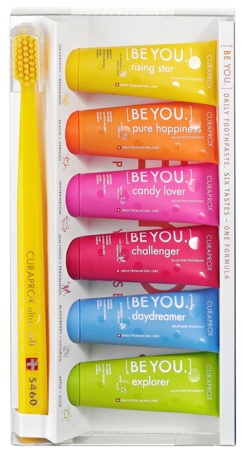 Six tubes of lip balm in different colors, each with a unique name and message, in a white box.