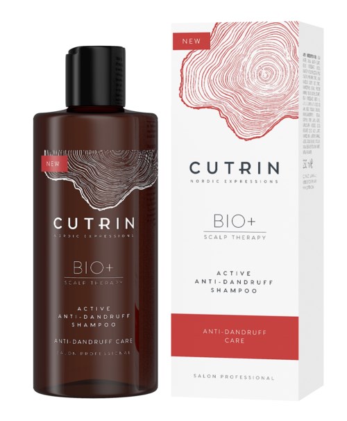 Eine braune Shampooflasche und eine weiße Box mit roten Akzenten für Kopfhauttherapie und Anti-Schuppen-Behandlung.