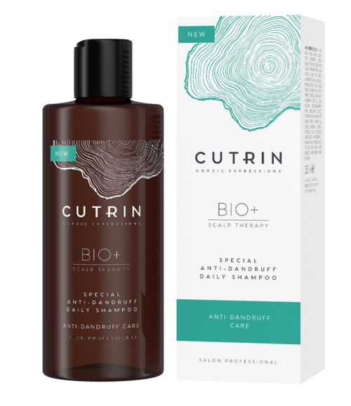 Eine braune Shampoo-Flasche und eine weiße Verpackung mit blauer und schwarzer Schrift für Kopfhauttherapie und Schuppenpflege.