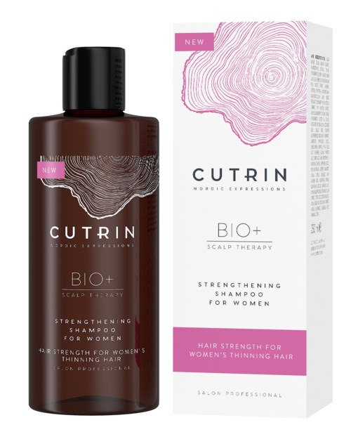 Eine braune Shampoo-Flasche mit pinker und weißer Verpackung und zugehöriger Schachtel, beide mit pinkem Fingerabdruck.