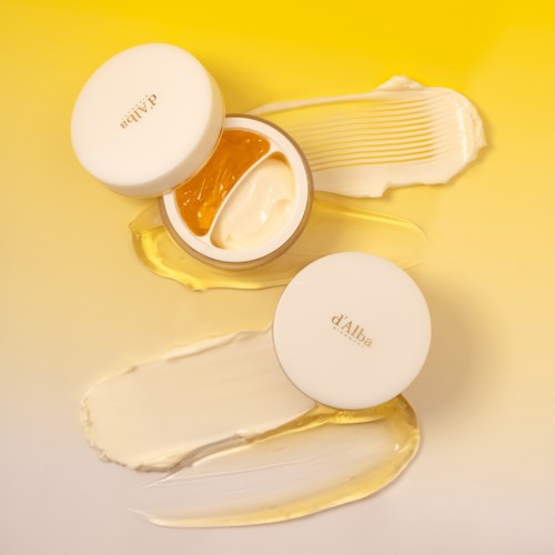 Zwei offene Cremetöpfe mit weißen Deckeln, zeigen Creme und Gel, mit Creme auf gelbem Untergrund.