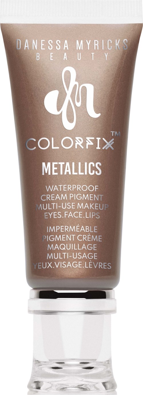 Bruine tube met waterdichte multifunctionele make-up voor ogen, gezicht, lippen; gemerkt 'Metallics' door Danessa Myricks Beauty.