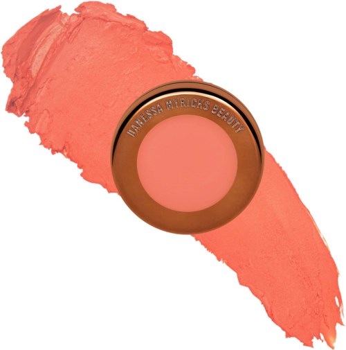 Runder Puder mit rosigem Rouge, beschriftet Vanissa Byricks Beauty, auf einem rosa Streifen. Es sieht nach Make-up aus.