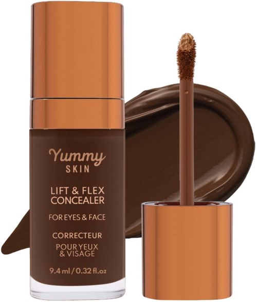 Concealer bottle with a doe-foot applicator, placed in front of a smear of dark brown makeup.