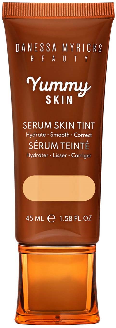 A brown tube of Danessa Myricks Beauty Yummy Skin Serum Skin Tint with orange cap, 45 ml. Text shows product benefits.