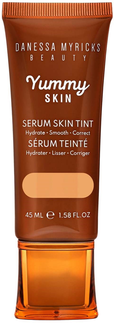 A brown tube of Danessa Myricks Beauty Yummy Skin Serum Skin Tint with orange cap, labeled for hydration and smooth skin.