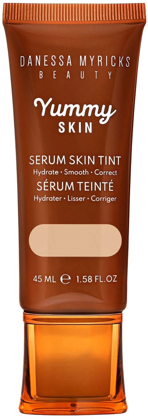 A brown tube with orange cap, labeled as Danessa Myricks Beauty Yummy Skin Serum Skin Tint, 45 ml.