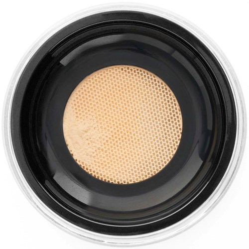 Krämig foundation i ett kompakt med en beige svampapplikator synlig inuti.