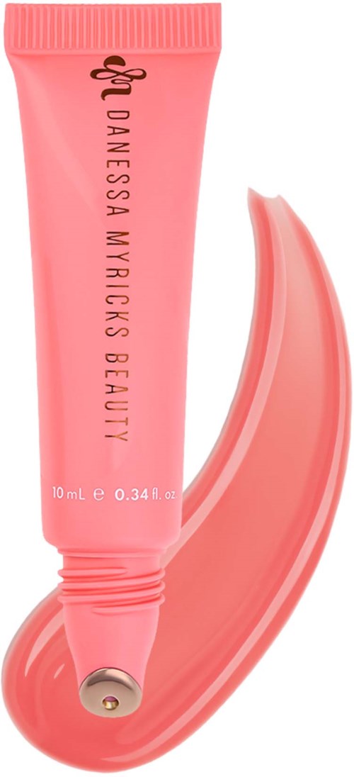 Vaaleanpunainen putkilö skincare-tuotteelle ja sivellin näytteenä.