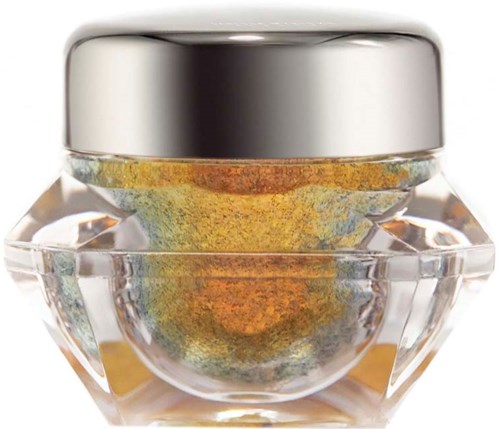 A small glass jar with a silver lid contains colorful shimmering loose powder, likely a highlighter or eyeshadow.