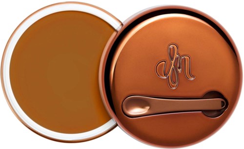 Round container with a lid, the lid has a monogram and a handle. The container appears to hold coffee or tea.