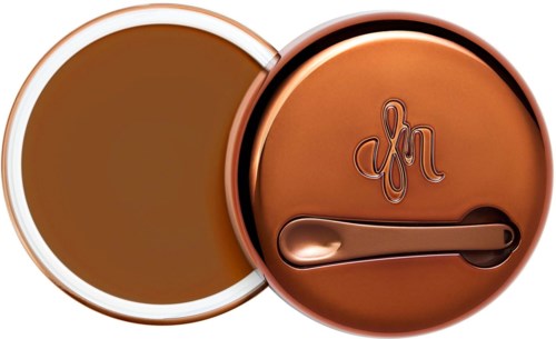 A compact container with a lid and a small spoon inside, both in shiny copper color.