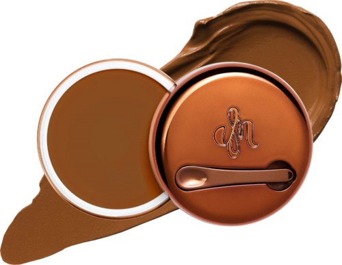 A brown cosmetic container with a lid and a small spatula, possibly for cream or moisturizer.