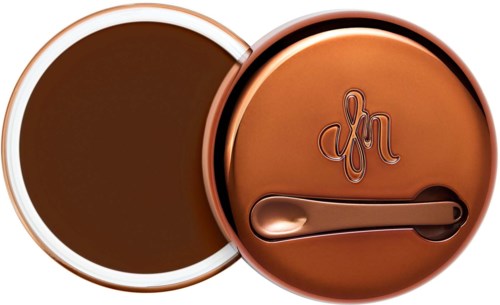 Round copper-colored container with a lid, embossed with a logo and a small spatula inside.