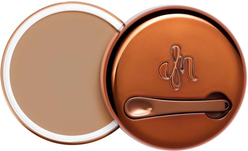 A compact powder case with a mirror and an engraved lid featuring a letter design, in rose gold color.