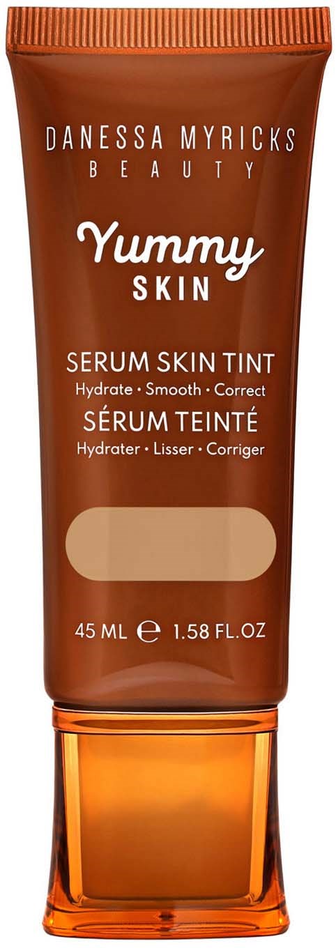 A brown tube with an orange cap, labeled as serum skin tint by Danessa Myricks Beauty for hydrate and smooth skin.