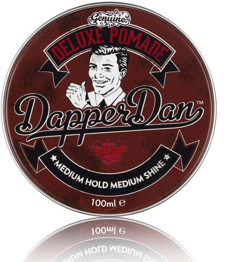 A round, red tin container with a retro style logo, men smiling, and text about pomade and styling.