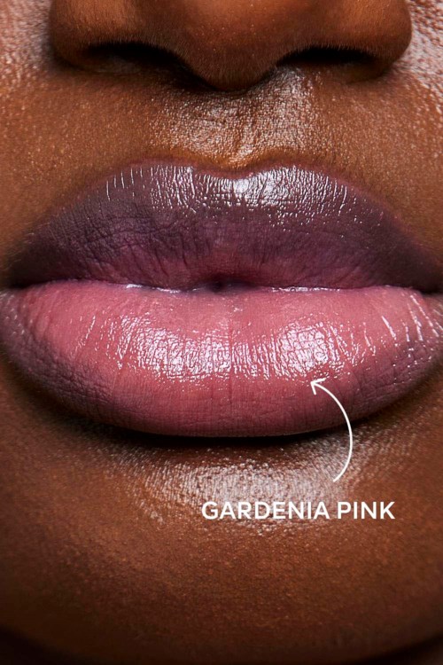 Close-up of lips with pink gloss, showing the label 'Gardenia Pink.'