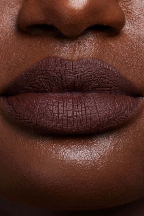 Close-up of dark lips and nose area, showing textured skin and natural features.