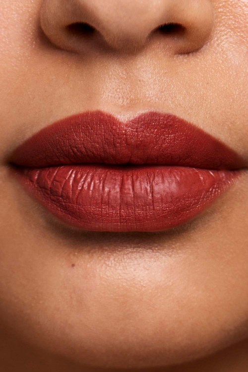 Close-up of lips with dark red lipstick and smooth skin around the mouth.