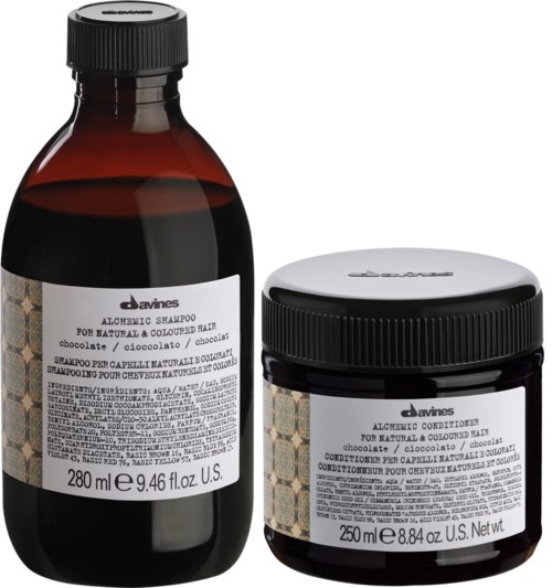 Two dark bottles, one with shampoo and the other with conditioner, both labeled for natural, colored hair, with white caps.