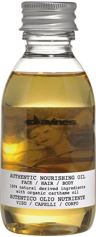 Small bottle with yellowish oil, labeled as nourishing oil for face, hair, and body, made from natural ingredients.