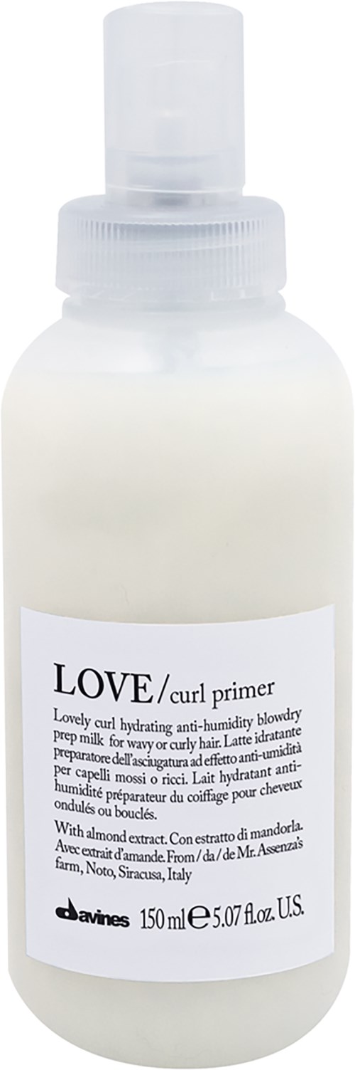 A white bottle with a spray top labeled "LOVE/curl primer," containing 150 ml of hair product for curls.