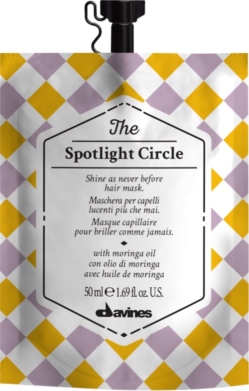 En hårpleiepose med gull og lilla diamanter, merket 'The Spotlight Circle' og produktdetaljer.