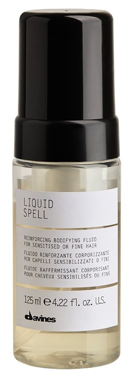A small clear bottle with a black cap, labeled 'Liquid Spell' for hair treatment, holding 125 ml of product.
