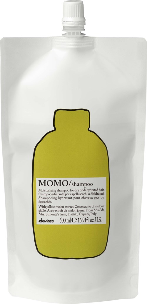 En vit schampotäcke med en gul flaska och svart text. Den är märkt 'MOMO/shampo' och innehåller 500 ml.