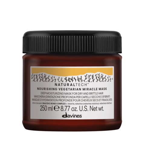 En burk med Davines Nourishing Vegan Hair Mask med svart lock och vit etikett, visar produktspecifikationer.