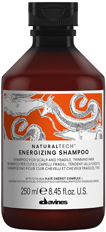 En brun flaska med Davines Energizing Shampoo med en drakillustration på etiketten.