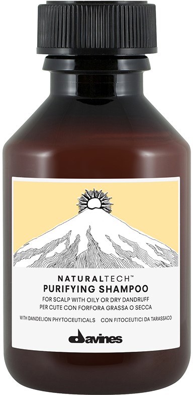 A brown bottle of natural tech purifying shampoo for scalp with oil or dandruff. It has a black cap and a label with a mountain and sun.