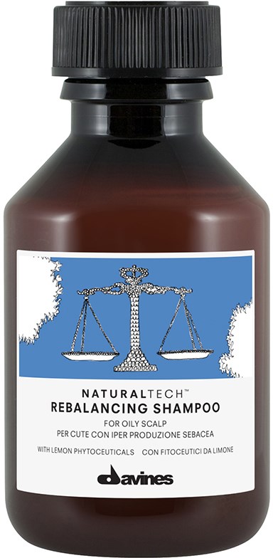 En brun flaska med naturligt balanserande schampo med en blå etikett som visar en våg och produktdetaljer.