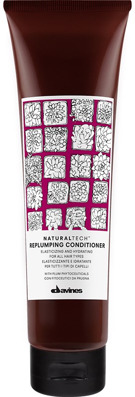 En brun tub märkt 'Replumping Conditioner' med blommönster och rosa detaljer. Den är för hårvård och återfuktning.