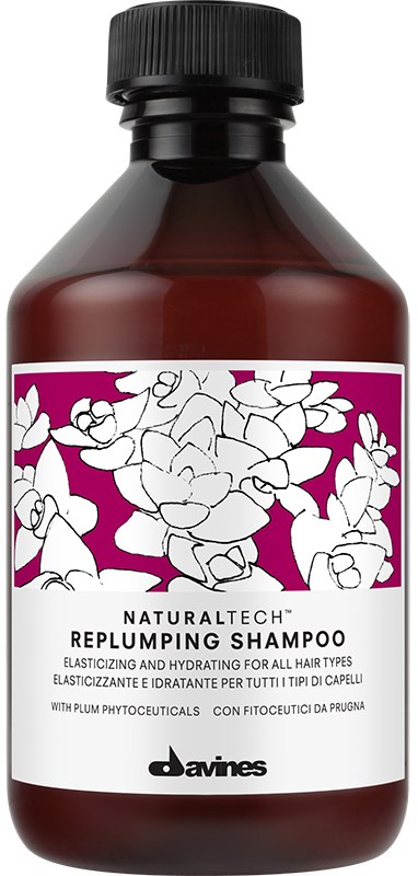 En brun flaska av Davines Replumping Shampoo med en rosa och vit etikett med blommor och blad.