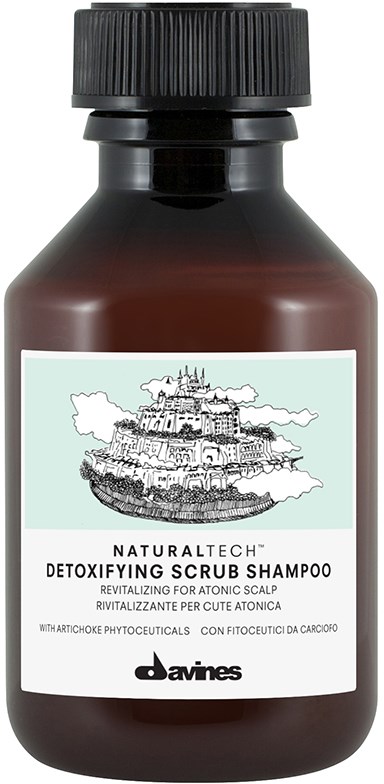 En mörkbrun flaska med svart lock, märkt som detoxifierande skrubbschampo för hårbotten, med en teckning av ett slott.