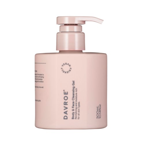 A pink bottle with a pump, labeled DAVROE, containing body and face cleansing gel, vegan, 300ml.