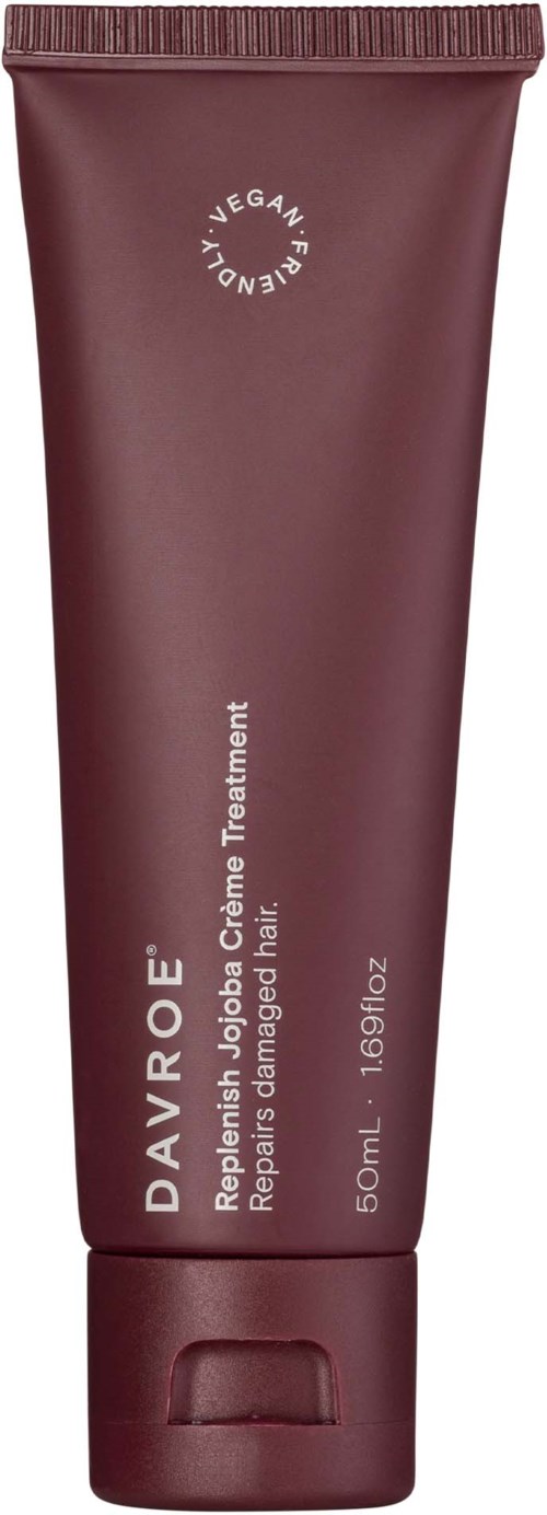 A maroon tube of Dayrø facial cream with white text and a circular vegan label.