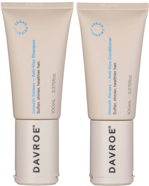 Zwei beigefarbene Tuben, gekennzeichnet als Shampoo und Conditioner, stehen nebeneinander. Sie haben blaue Schrift und schwarzen Markennamen. Kleine Größe.