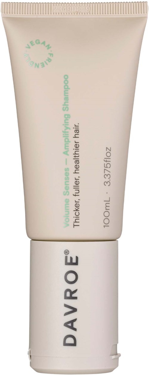 A tube of Davroe shampoo labeled for volume, thickness, and healthier hair, 100ml size with a clean design.