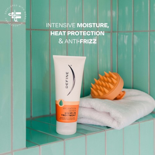 A hair care product tube with a brush and towel on a tiled shelf, promoting moisture and heat protection.
