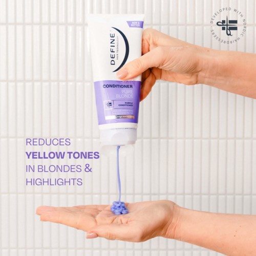 A hand holds a purple and white conditioner tube, dispensing purple gel onto the palm of the other hand.