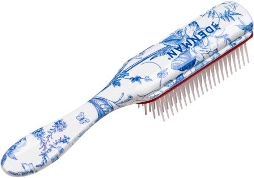 Eine Haarbürste mit weißem und blauem Blumenmuster, mit dem Wort JODEMAN und vielen Borsten auf einer Seite.