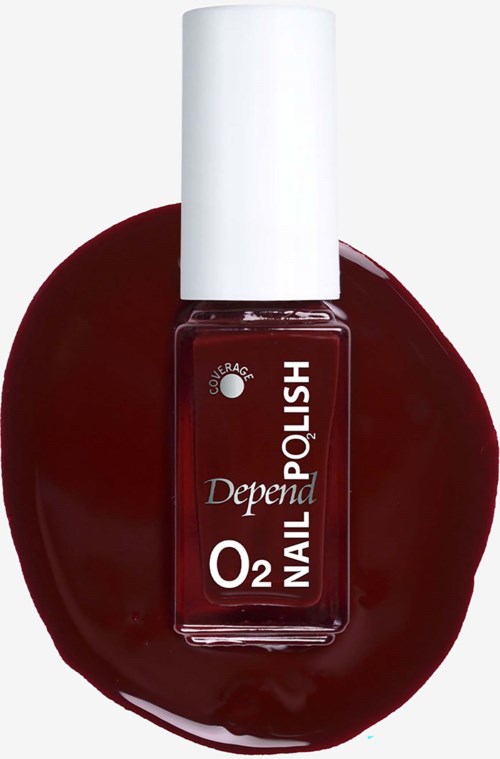 A bottle of Depend O2 nail polish on a dark red, glossy surface.