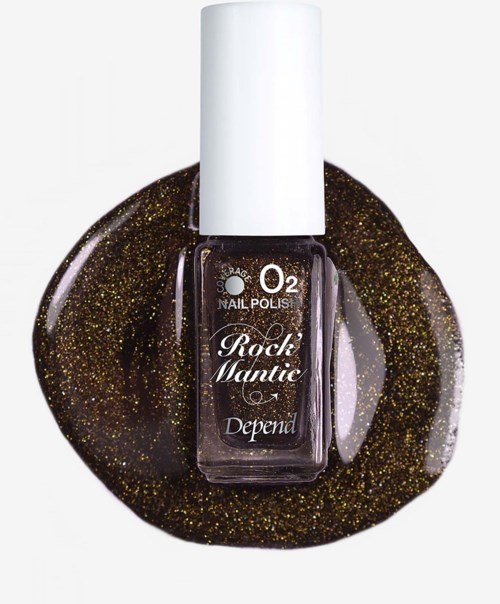 En nagellacksflaska märkta Rock Mantic med guldglitternagellack som spillts runt den.