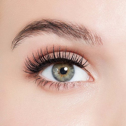 Close-up of a blue eye with makeup and long eyelashes.