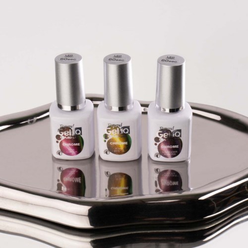 Three bottles of gel nail polish stand on a silver reflective surface, with black cables in the background.